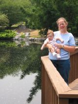Jonna holding Ariella over the pond
